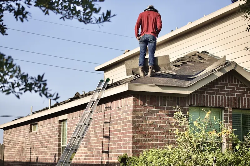 Professional roofer working on a residential roof in Crotonville